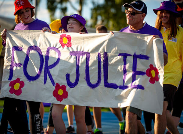 Relayers carrying a home-made banner with the words 'For Julie'